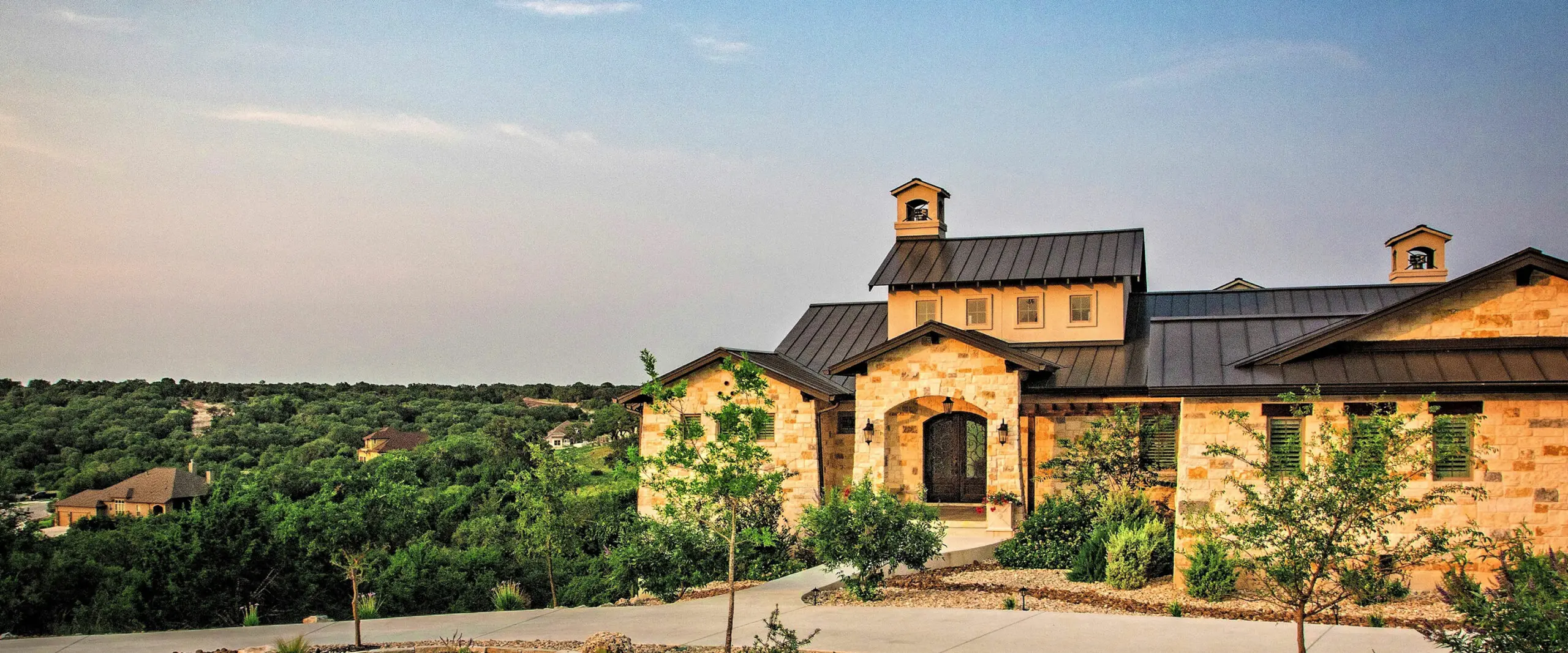 A home with a stone roof and a stone driveway.