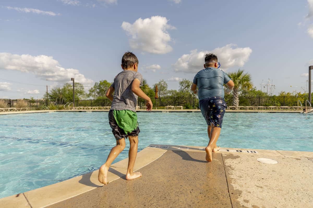 Young boys jump into a Mission del Lago pool.